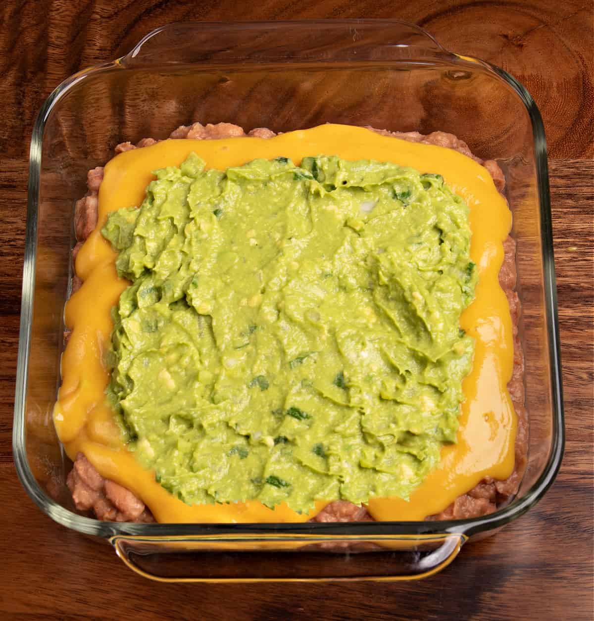 Top down photo of my vegan 7 layer dip topped with fresh vegan guacamole