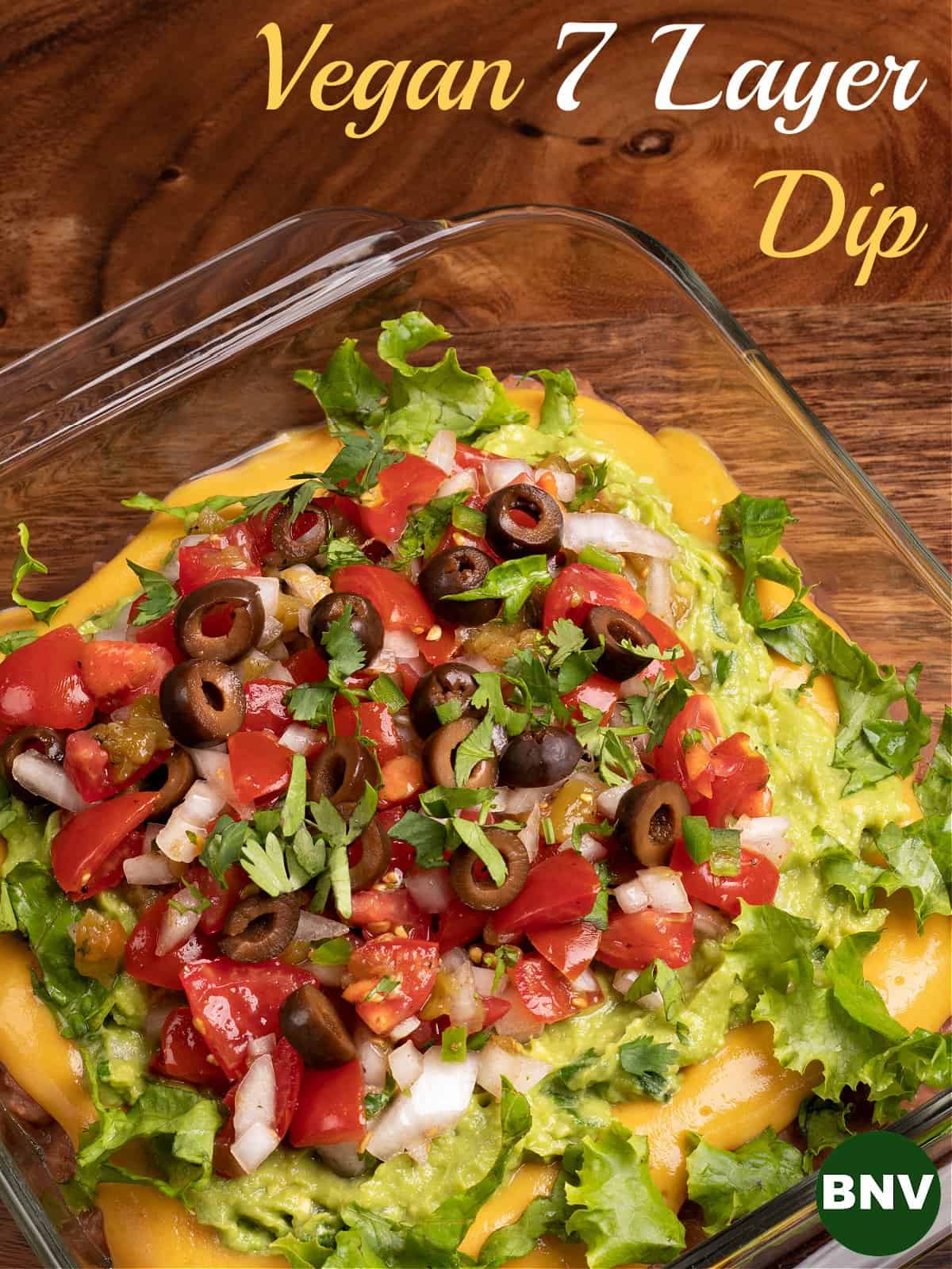top down photo of my vegan 7 layer dip topped with Pico De Gallo and black olives