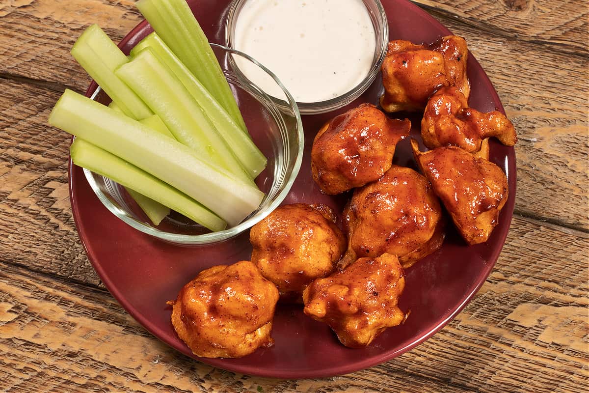 bbq cauliflower wings with a side of vegan ranch and celery