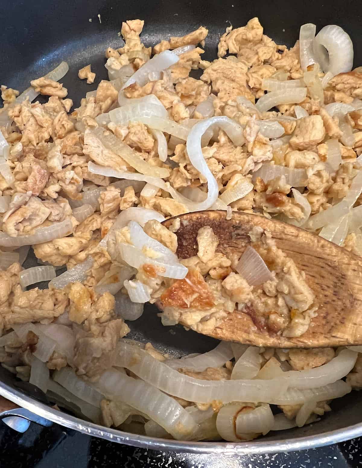skillet with onions and soy curls to make vegan tinga