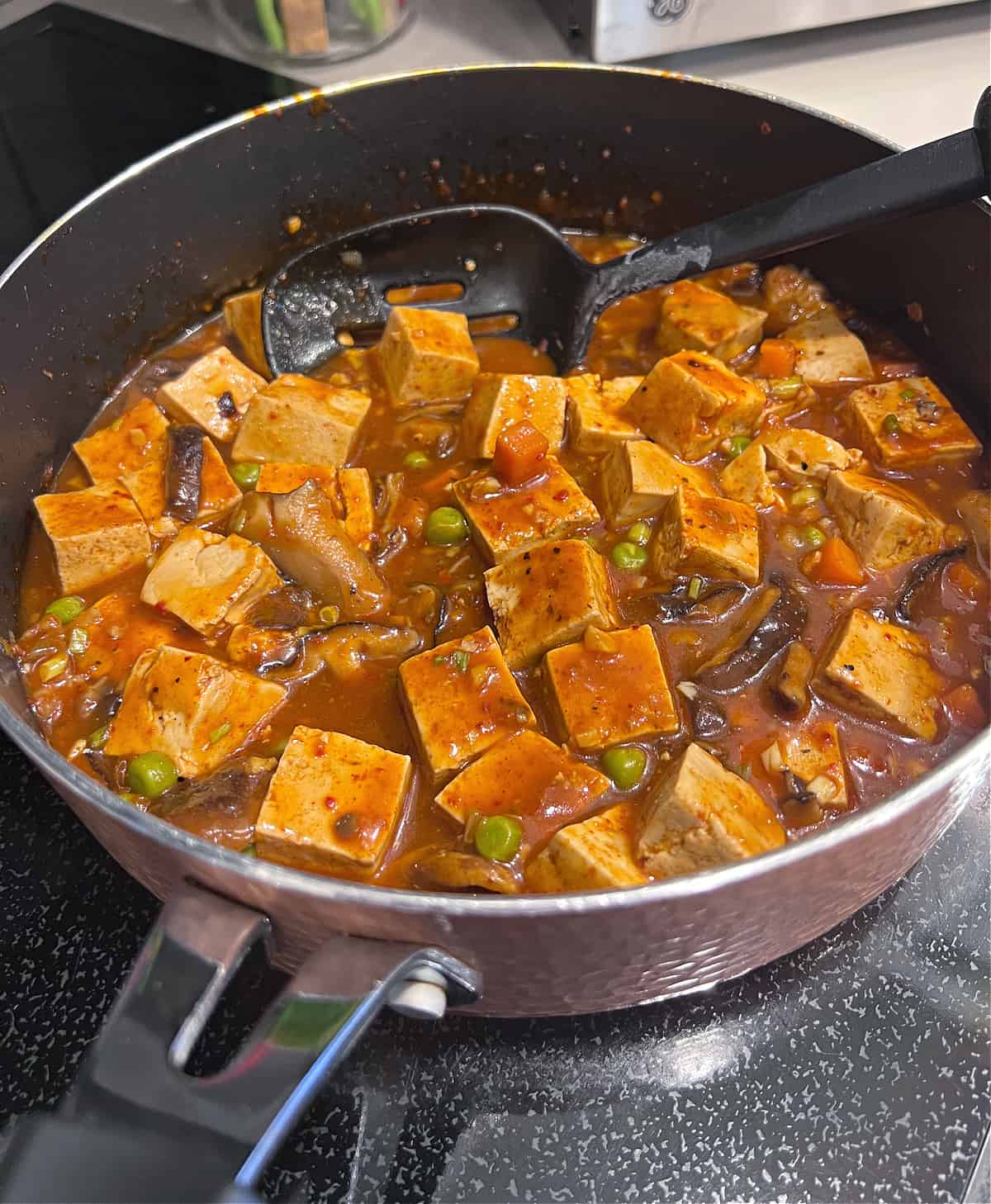 mapo tofu cooking in a pan
