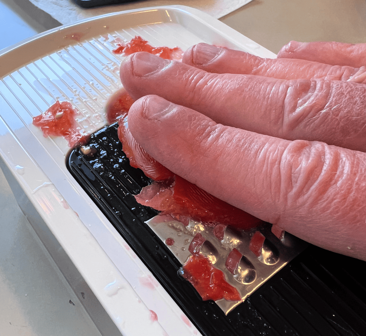 grating tomatoes on a fullstar 7-1 food chopper