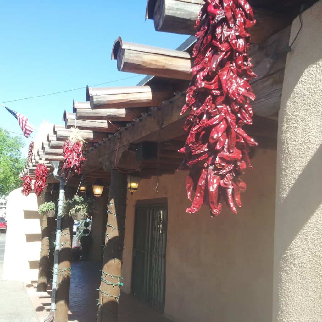 New Mexico building with red Chile Pepper ristras hanging from the roof
