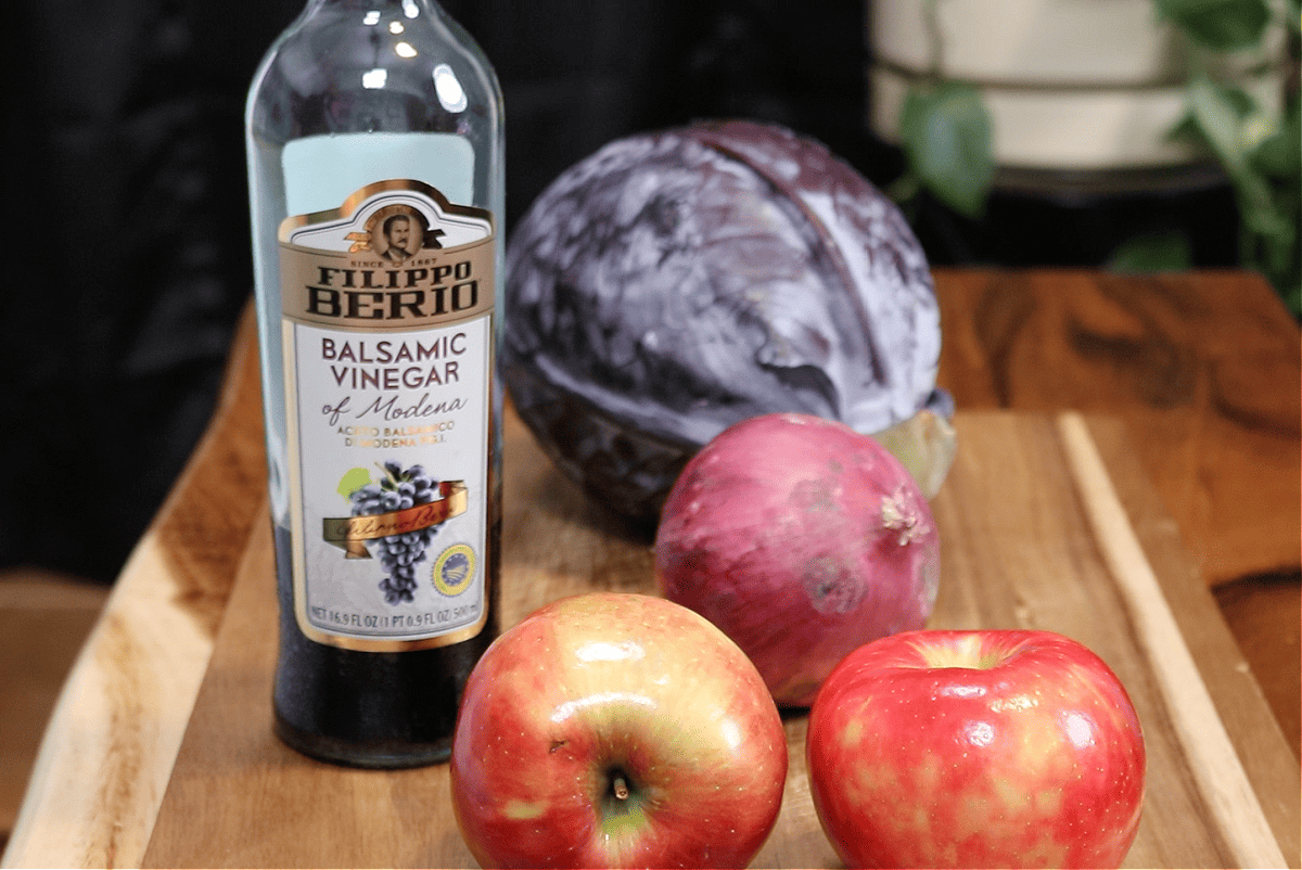 ingredients for braised red cabbage and apples.  red cabbage, red onion, honeys crisp apples, and balsamic vinegar