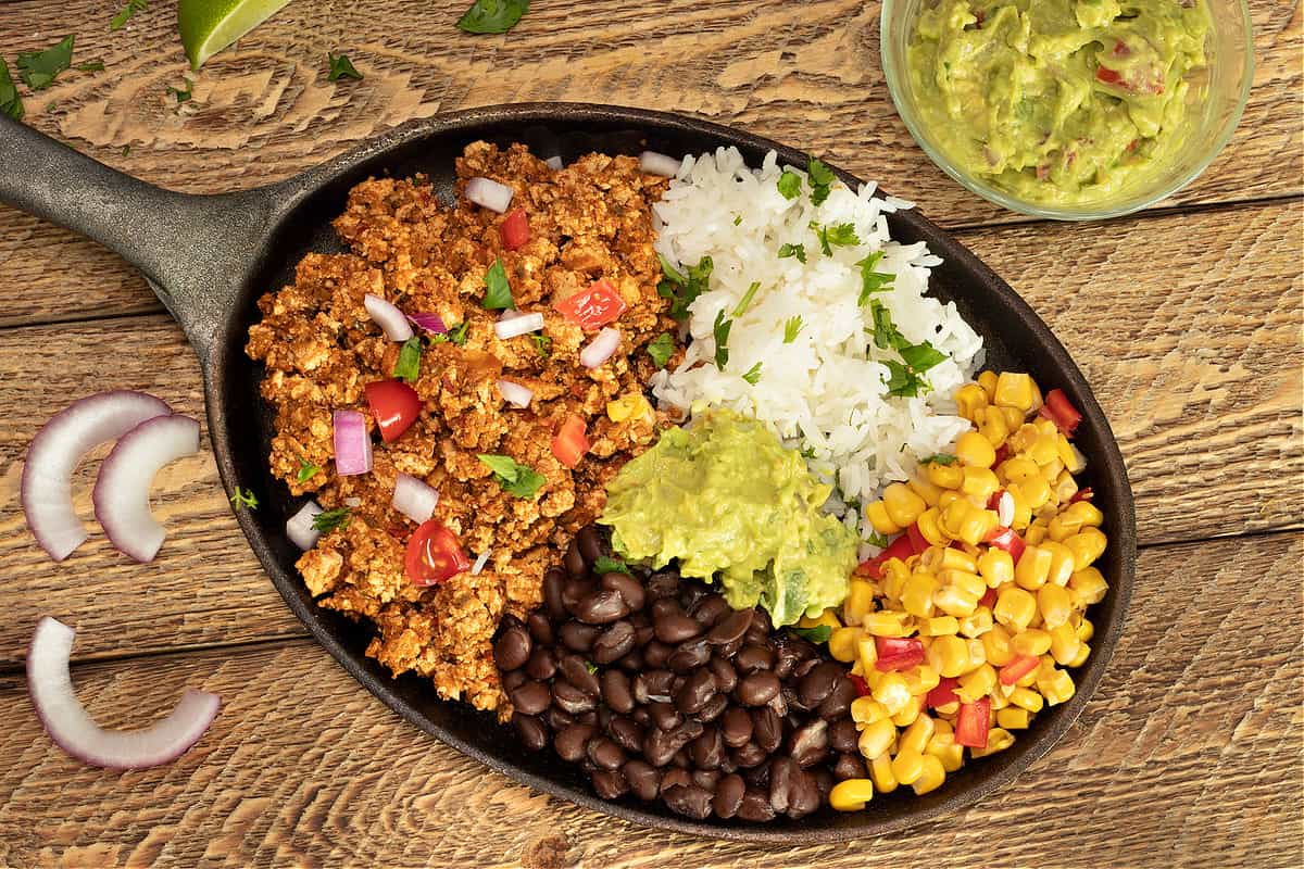 mexican tofu sofritas with black beans, rice, fire-roasted corn. and guacamole