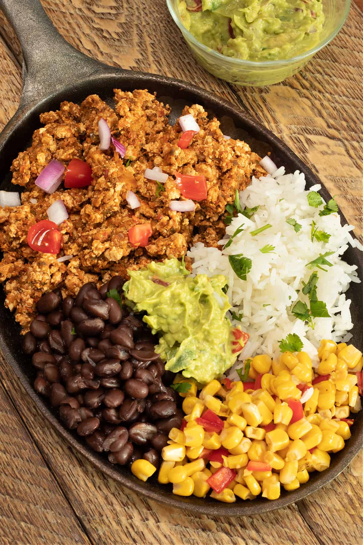 mexican tofu sofritas with black beans, rice, fire-roasted corn. and guacamole