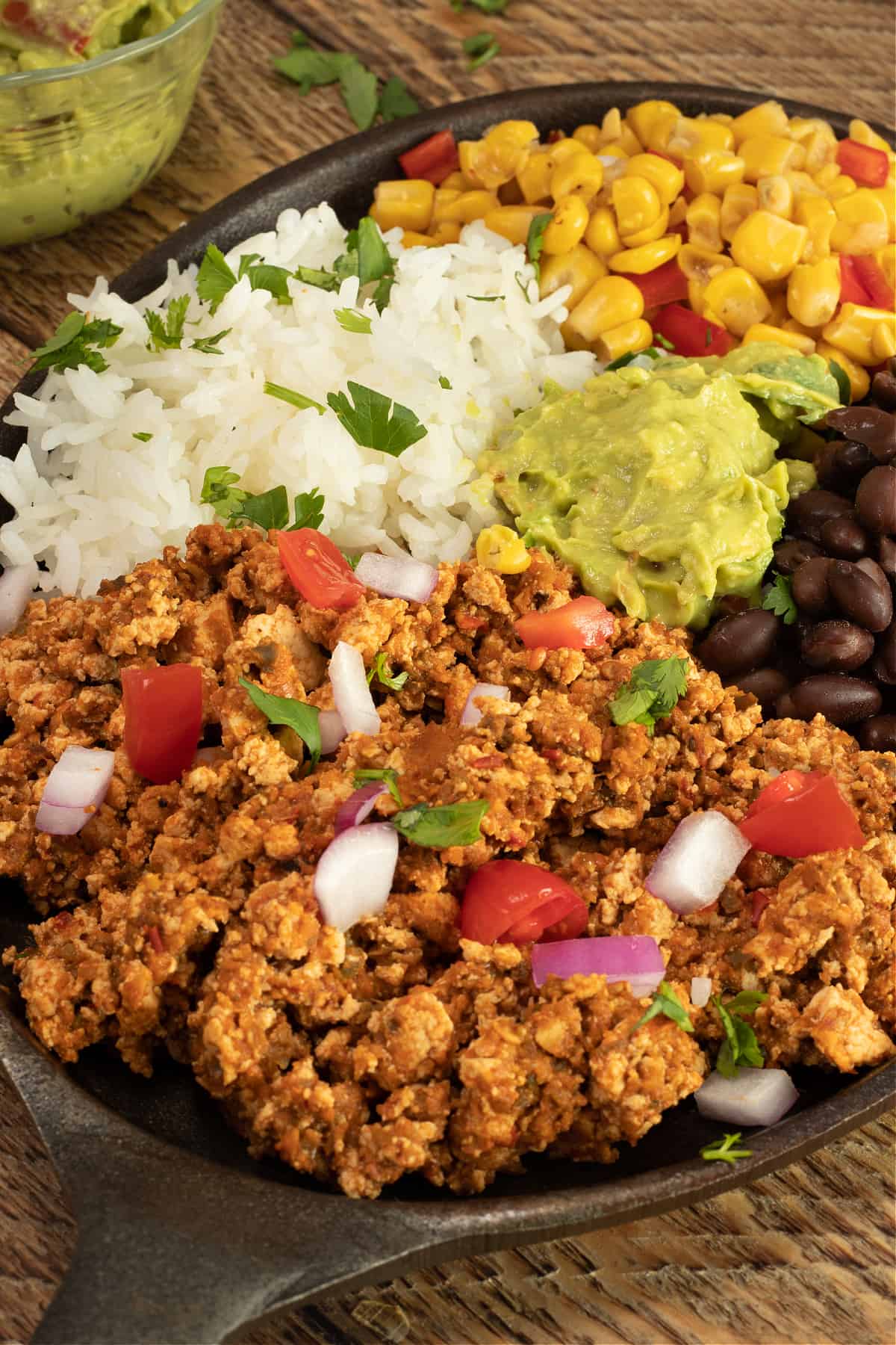 mexican tofu sofritas with black beans, rice, fire-roasted corn. and guacamole