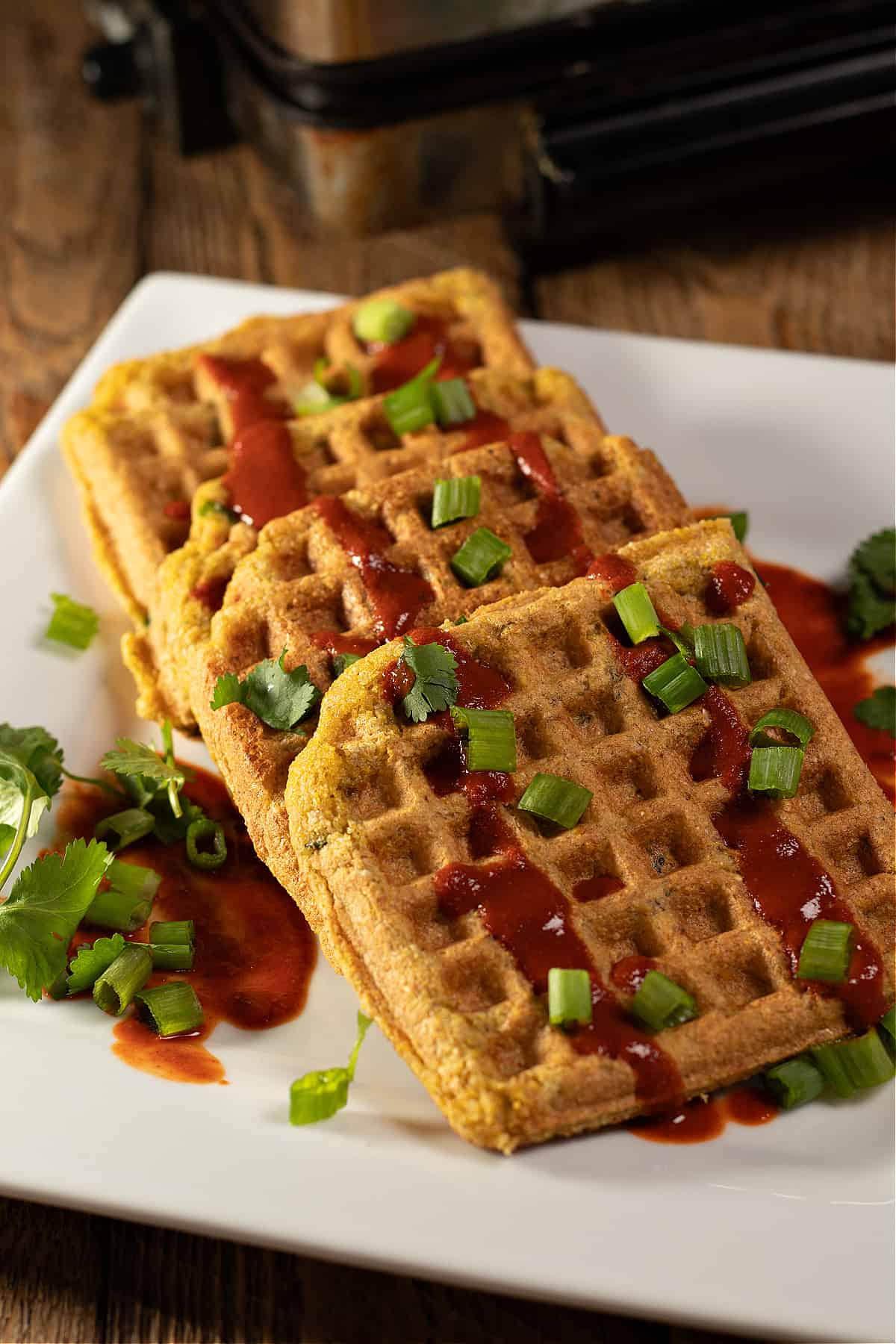 gluten-free cornbread waffles drizzled in red Chile sauce