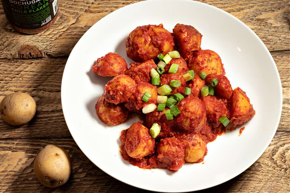 plate of baby potatoes covered in gochujang