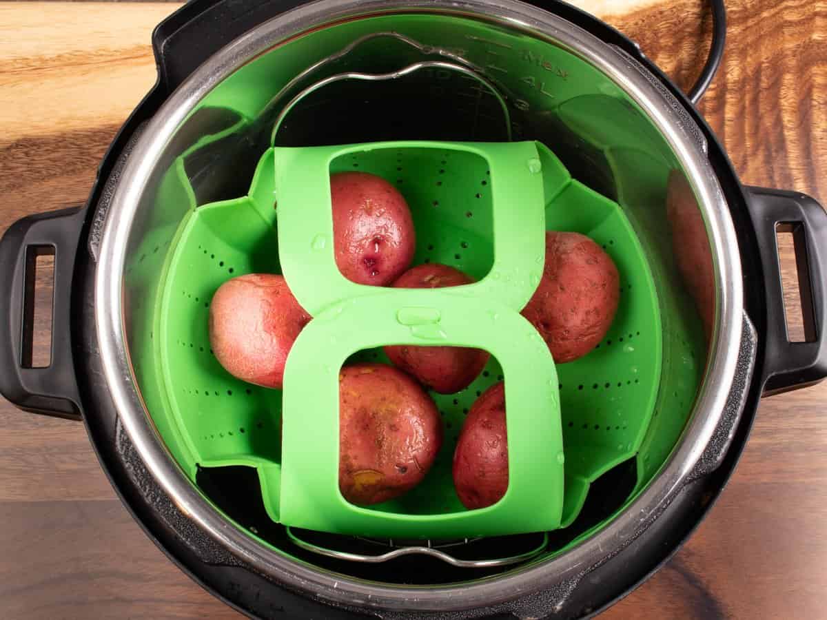 instant pot with steamer basket and 6 red potatoes