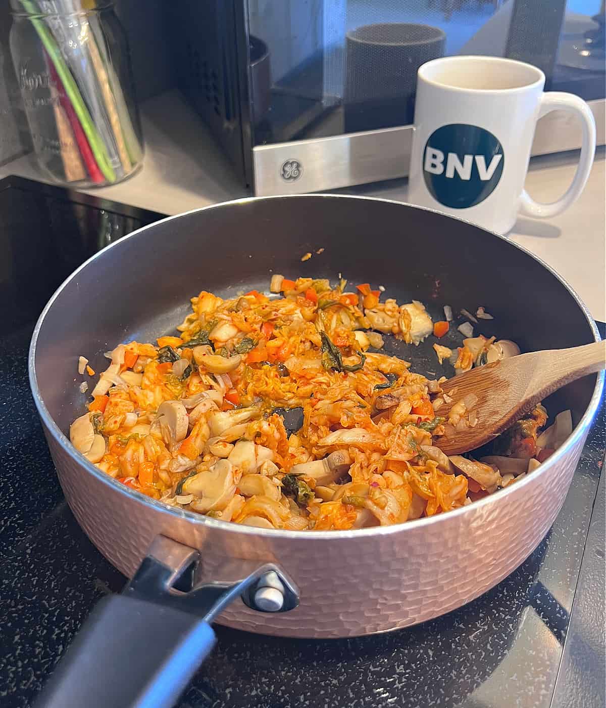 adding kimchi to vegan kimchi fried rice