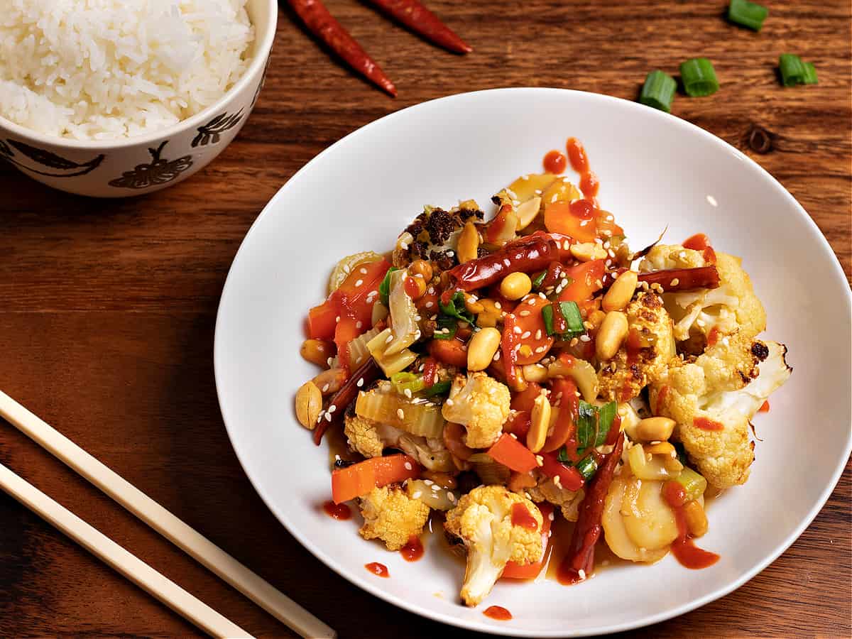 horizontal picture of Kung Pao cauliflower and a bowl of rice