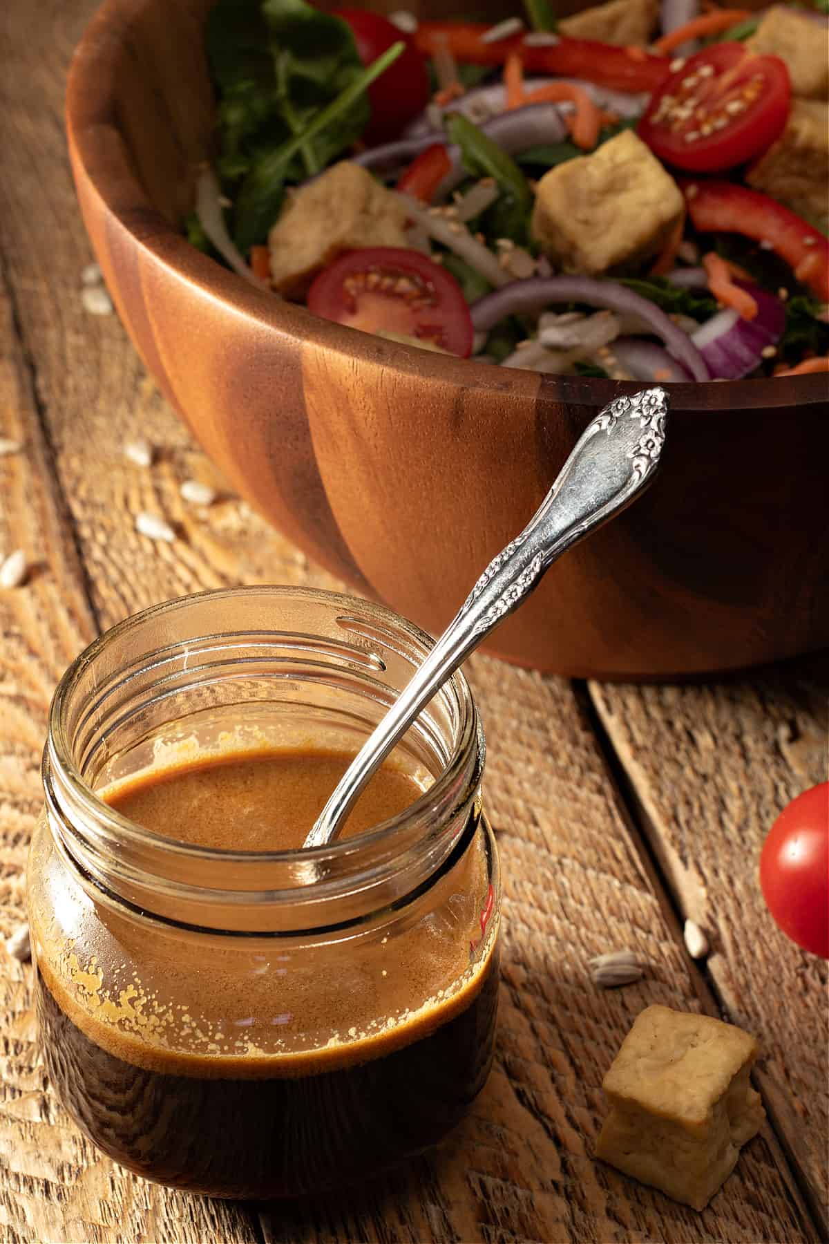 jar of last minute asian salad dressing ready to pour over a big salad