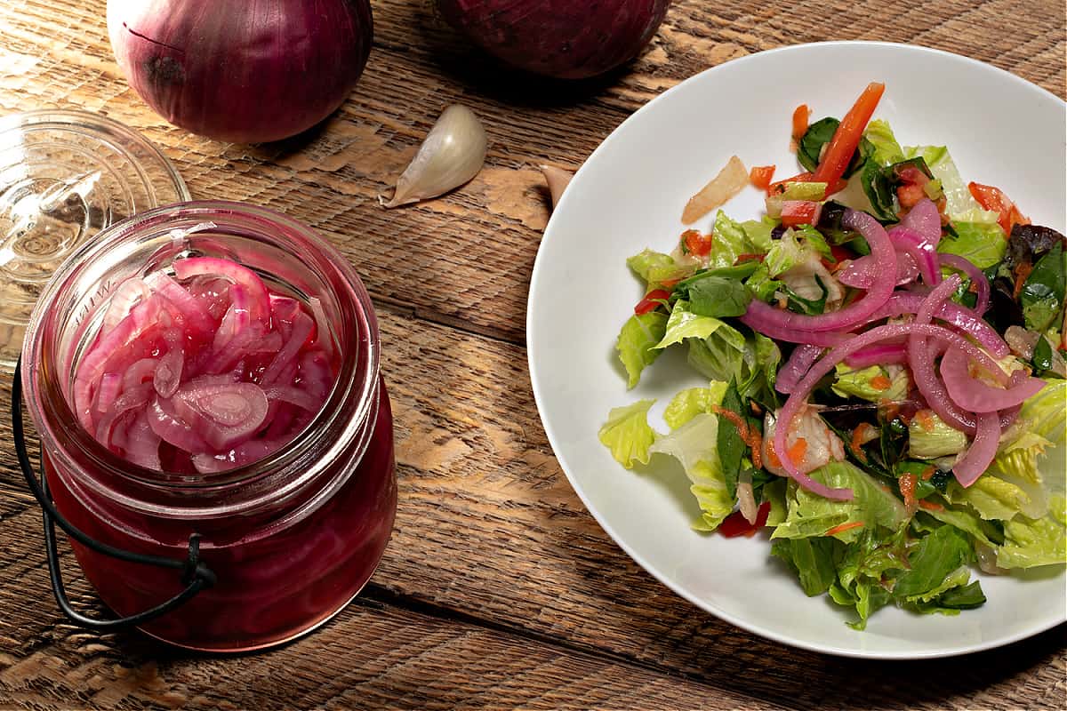 jar of pickled onions with a salad 