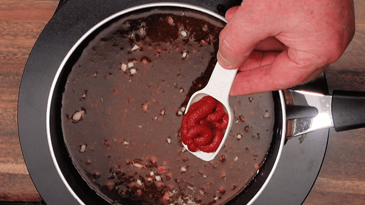 adding tomato paste to sweet chile sauce