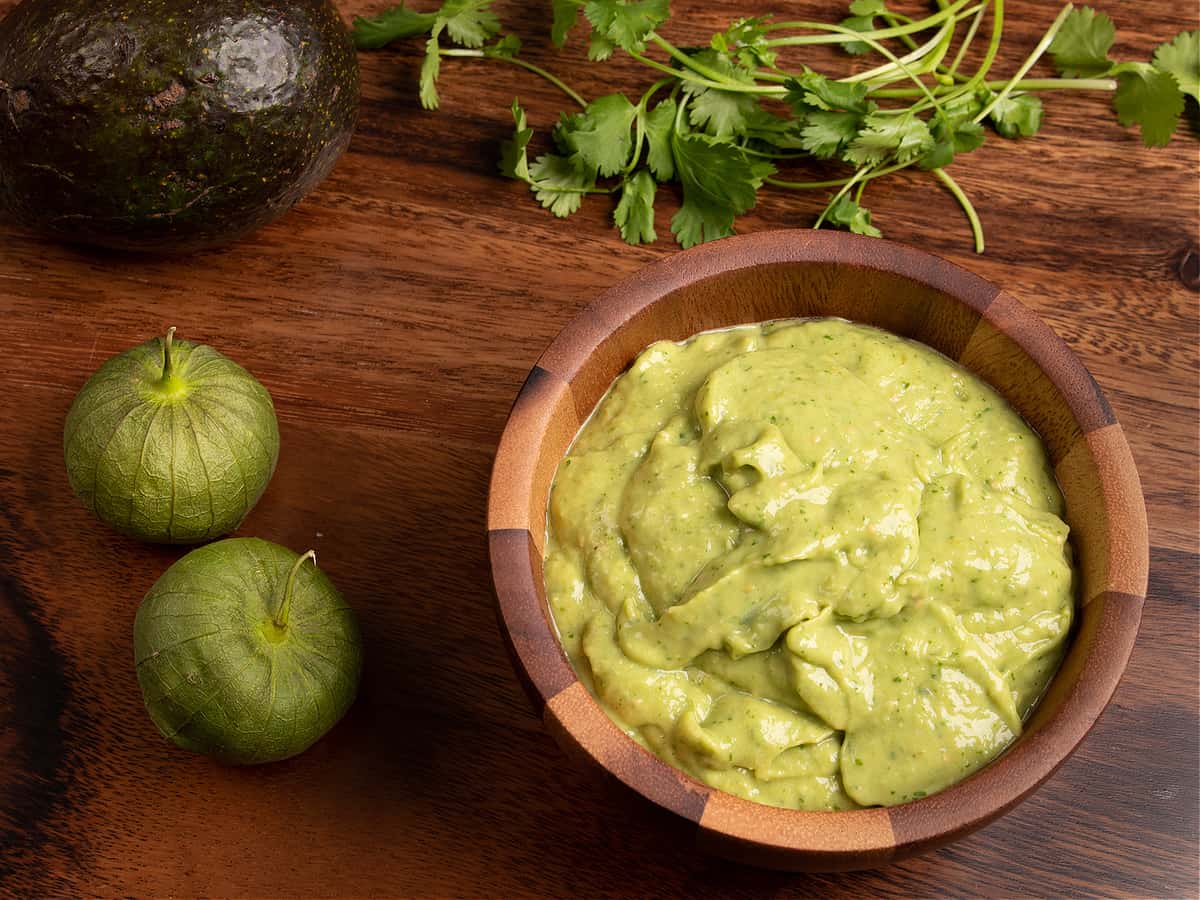 top down horizontal shot of my tomatillo avocado salsa in a wooden bowl