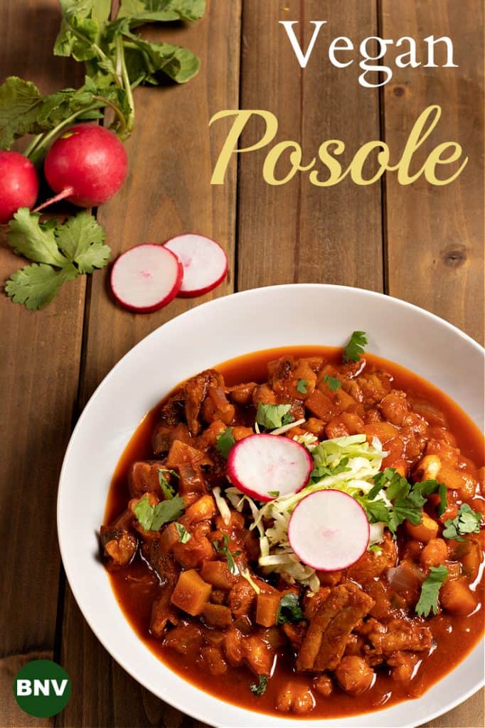 Pinterest size vertical photo of a bowl of vegan posole with garnishes