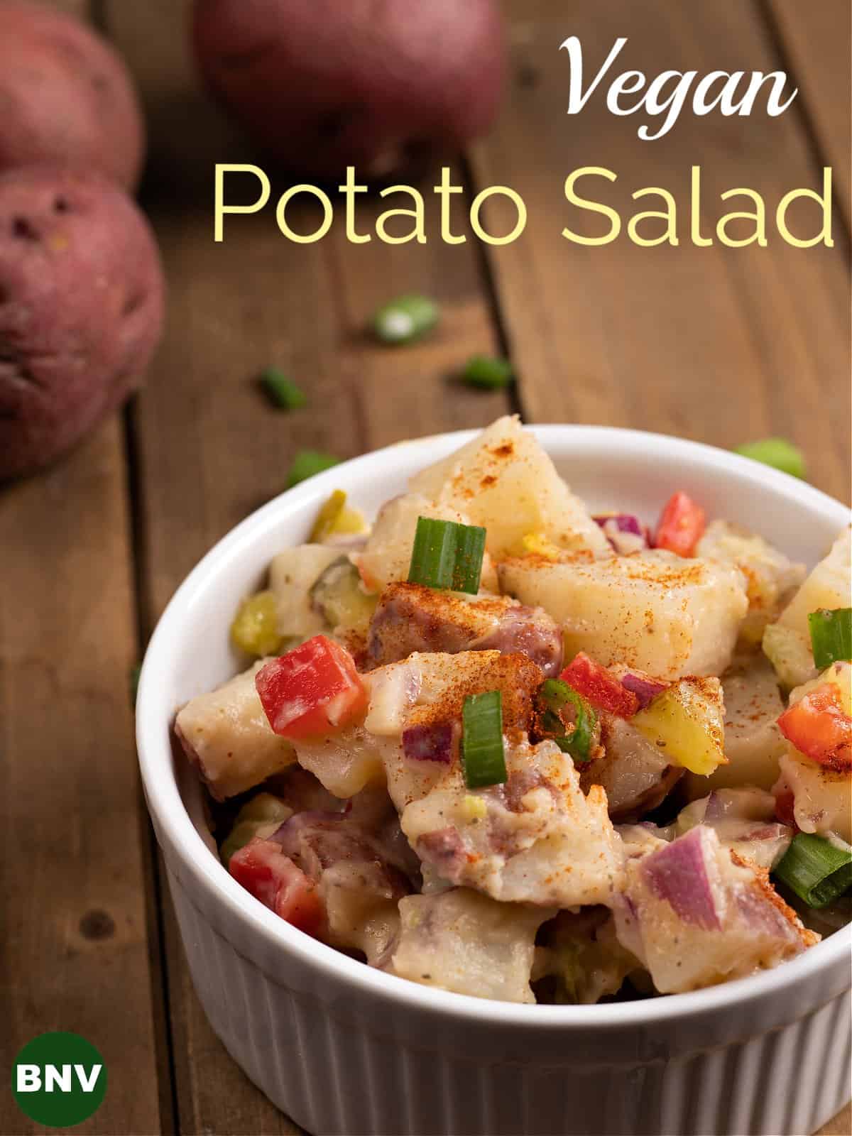 vertical photo displaying a bowl of vegan potato salad